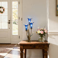 21"H Mercury Glass 3 Lily Uplight Accent Lamp on a wooden table next to a vase of flowers in a home setting.