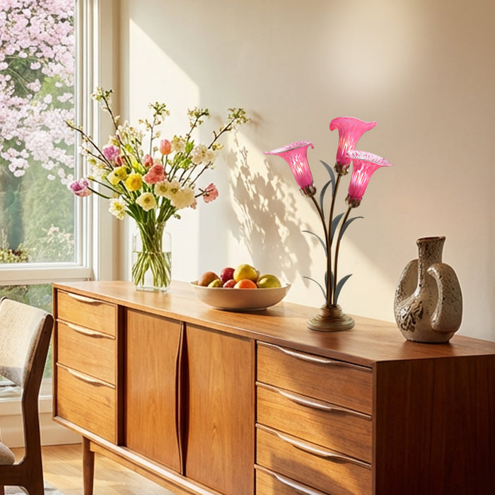 23.5"H Hand Blown Glass 3 Calla Lily Uplight Accent Lamp on a wooden sideboard with decorative items including a vase of flowers, and a fruit bowl