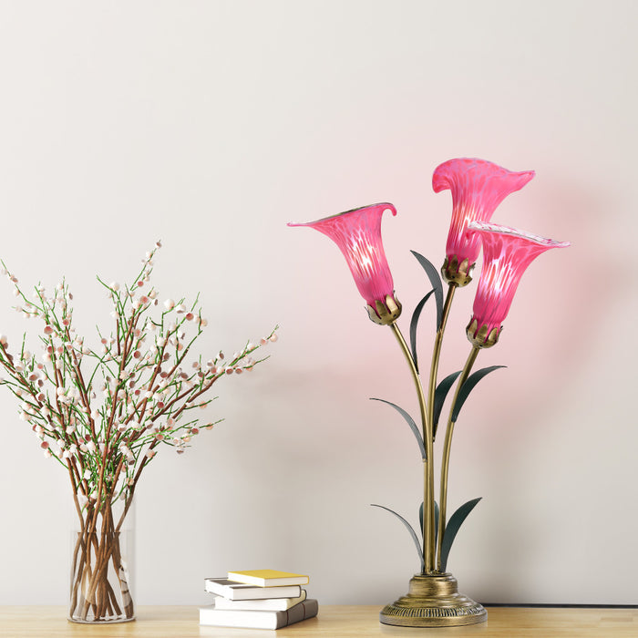 23.5"H Hand Blown Glass 3 Calla Lily Uplight Accent Lamp on a wooden surface with books and a vase in the background.