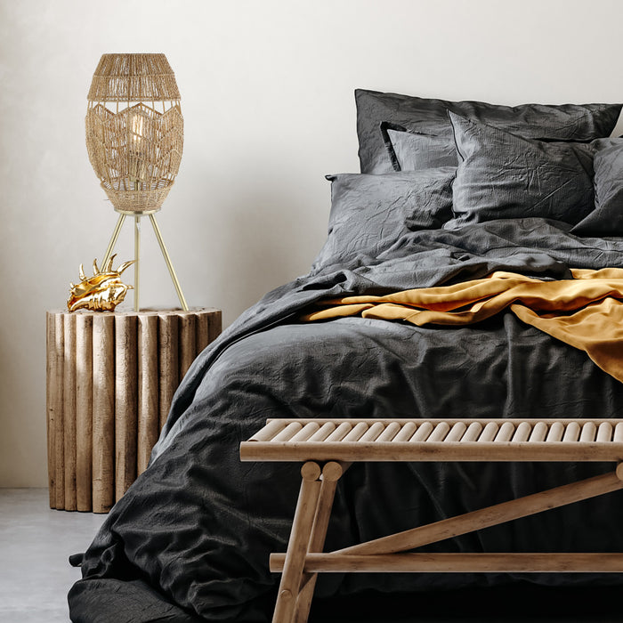 23.5"H Table Lamp with Round Tan Hemp Rope Shade in a bedroom with dark gray bedding and a wooden bench