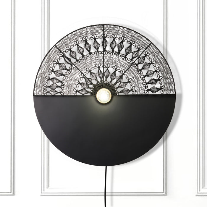 24" H Modern Black Indoor Plug In Wall Sconce on a white wall
