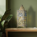 24"H Jeweled Turkish Table Lamp on a wooden surface with a plant in the background