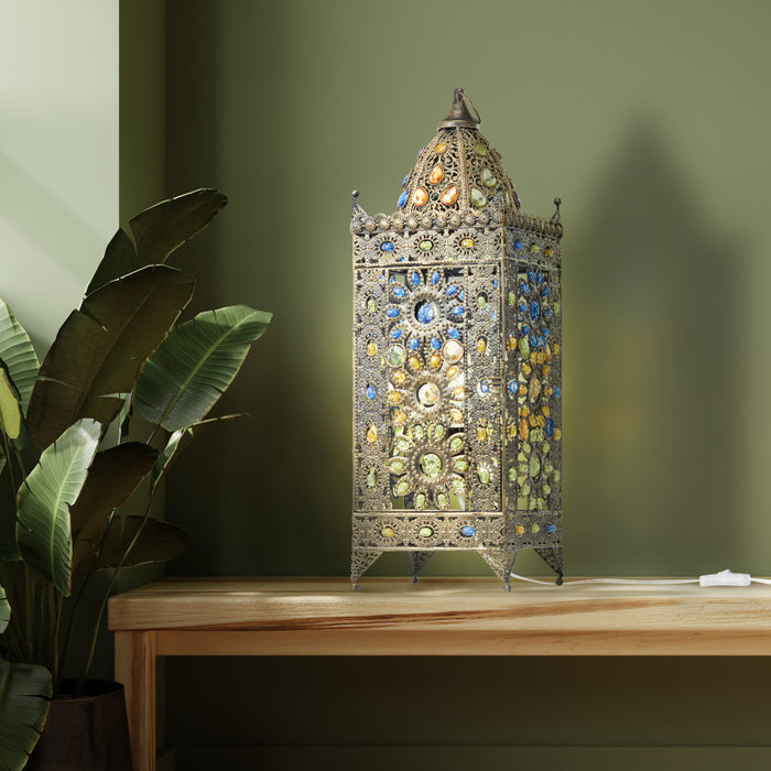 24"H Jeweled Turkish Table Lamp on a wooden surface with a plant in the background