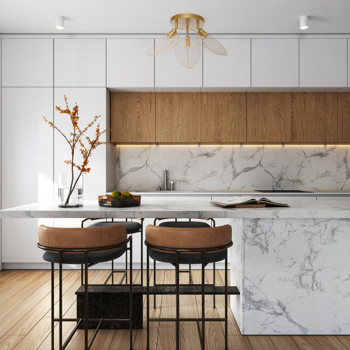 24"W Noelle Gold Leaf Shade Ceiling Light in a modern kitchen with marble countertops, wooden cabinets, and bar stools.