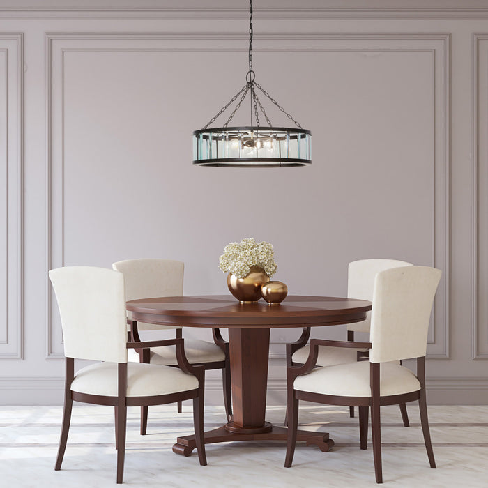 25" W 3-Light Gwen Black Metal and Glass Pendant in a dining room with wooden table and chairs.