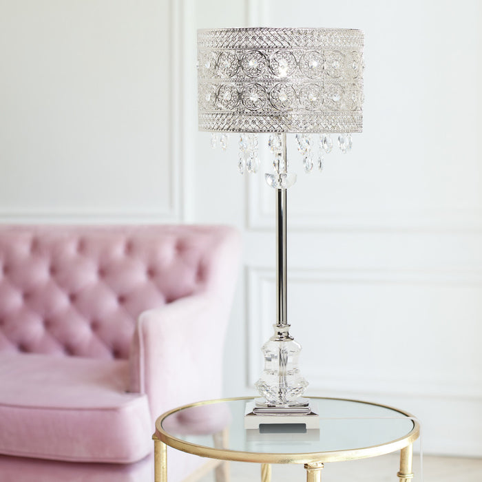 28.75"H Brielle Polished Nickel and Crystal 1-Light Buffet Table Lamp on a glass table in a room with a pink sofa.