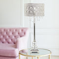 28.75"H Brielle Polished Nickel and Crystal 1-Light Buffet Table Lamp on a glass table in a room with a pink sofa.
