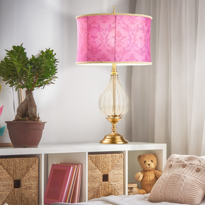 30.5" H Colette Fuchsia Drum Shade Geometric Glass Table Lamp on a white shelf with books, a plant, and a teddy bear.