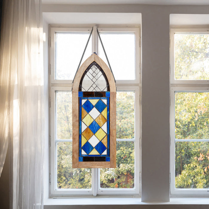 36" H Victorian Checkerboard Cathedral-Style Stained Glass Window Panel hanging in front of a window with a view of trees.