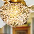 42" W LED Indoor Gold and White Mosaic Glass Ceiling Fan with Remote Control in a blurred living room with a fireplace