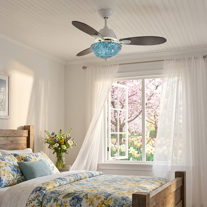 42" W Pierre LED Indoor Blue and Teal Mosaic Glass Ceiling Fan with Remote Control in a bedroom featuring a floral bedspread and cherry blossom view through windows.