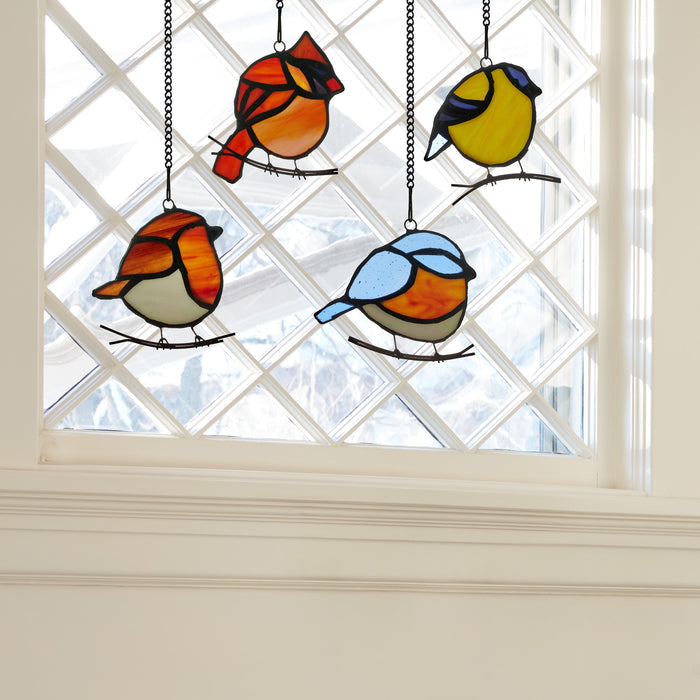 4.5" H Bird Quartet Stained Glass Window Panel Set hanging in front of a window