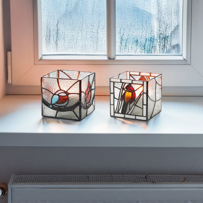 4.75" H Set of 2 Bird Stained Glass Candle Holders on a windowsill.