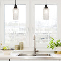 4.75" W 1-Light Haute Glass and Metal Pendant in a modern kitchen with sink, and window view