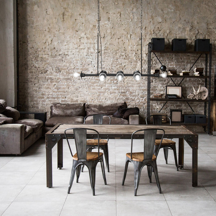 48" L 8-Light Degas Black Metal Industrial Chandelier in a modern dining area with a brick wall background