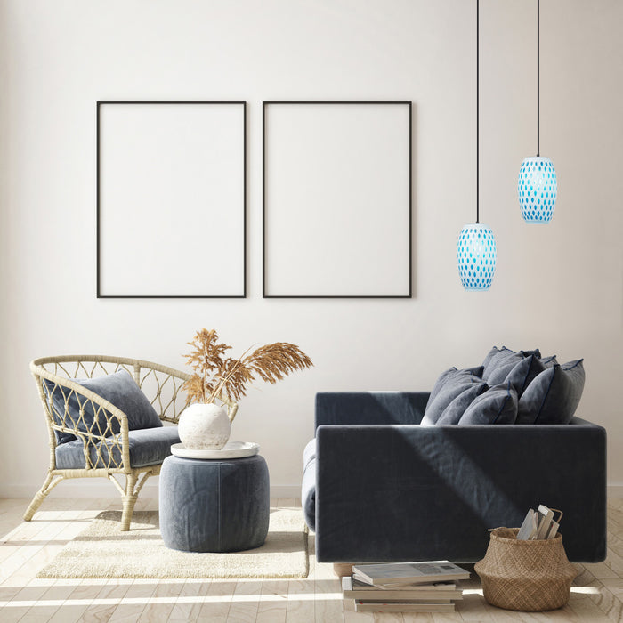 6" W Austin Glam White and Blue Glass Globe Shade Pendant Light hanging in a modern living room with a gray sofa, wicker chair, and decorative elements.