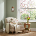 6.25" W 1-Light Betty Metal and Glass Pendant in a cozy living room with a beige armchair, floral cushions, and a small table with a vase of flowers.
