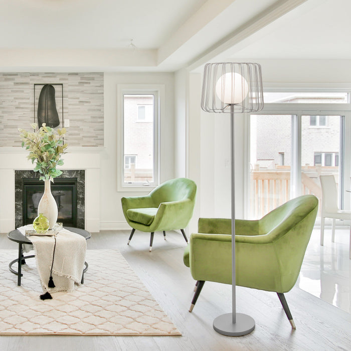 62.75"H Lucai Caged Globe Shade Floor Lamp Silver in a modern living room with green chairs and a fireplace.