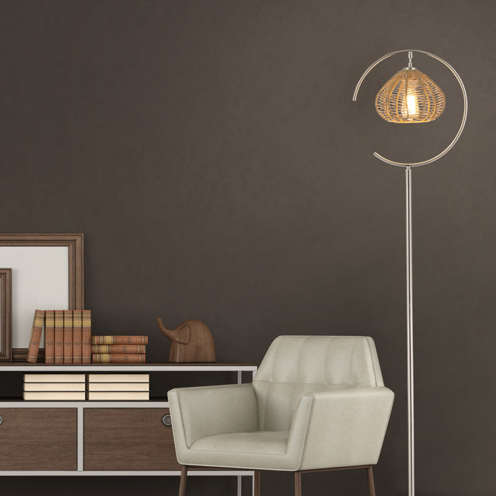 63.75"H Brushed Nickel Iron Floor Lamp & Tan Rattan Shade in a modern interior with a beige armchair and a wooden sideboard against a dark wall.