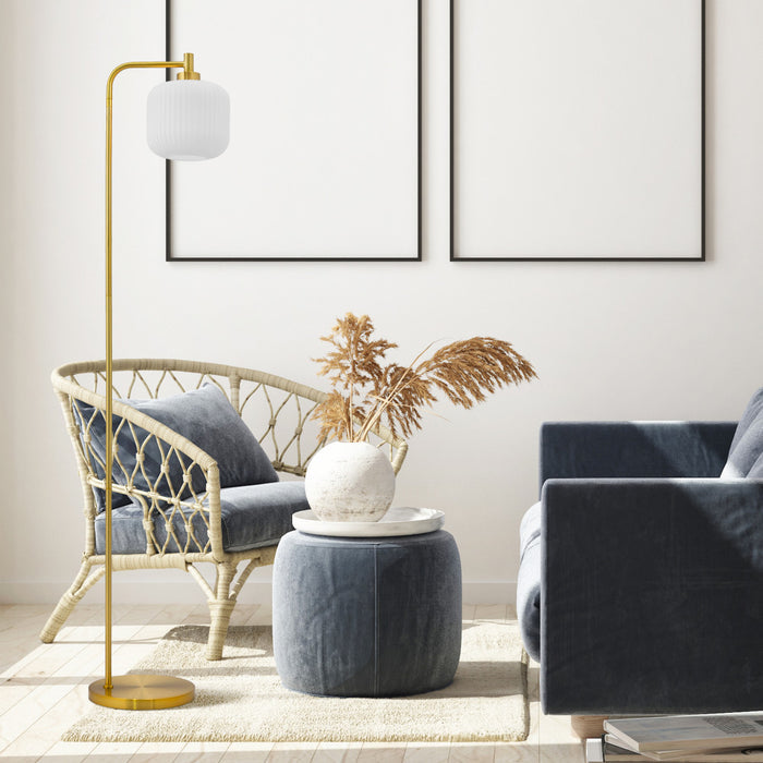 63"H Rowan Globe Shade Floor Lamp in a modern living room with gray sofa, wicker chair, and decorative elements.