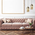 6.8'' W 1-Light Andrea Metal and Glass Pendant hanging above a pink tufted sofa in a living room with wooden floors.