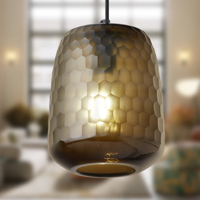 7" W Payton Retro Brown Hand Blown Glass Globe Shade Pendant Light with Hand Cut Honeycomb Design in a blurred indoor setting