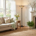71"H Stained Glass Mission Style Southwestern Torchiere in a living room with beige sofa and decorative pillows.