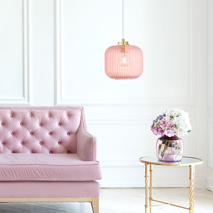 7.25"H Gael Retro Globe Shade Pendant Light hanging above a pink tufted sofa in a room with a small table with flowers.