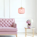 7.25"H Gael Retro Globe Shade Pendant Light hanging above a pink tufted sofa in a room with a small table with flowers.