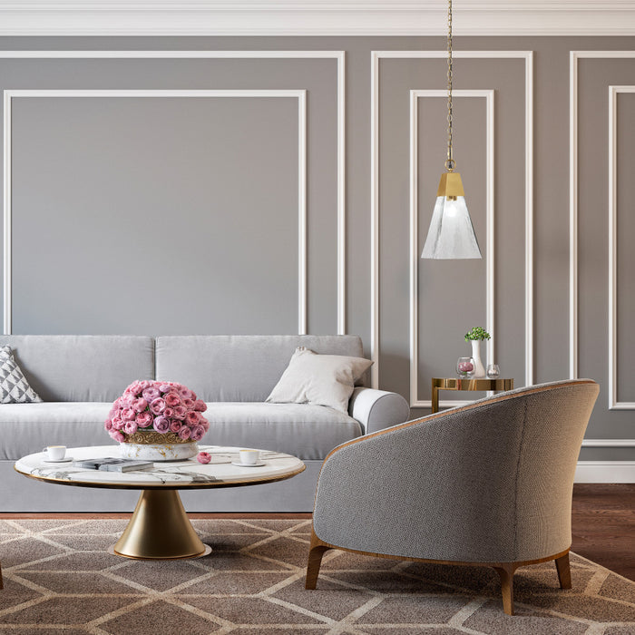 8" 1-Light Clear and Gold Cone Shaded Pendant in a modern living room with gray sofa, armchair, and decorative elements.