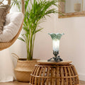 8" H Lily Glass Accent Lamp on a wooden stool with a plant and chair in the background