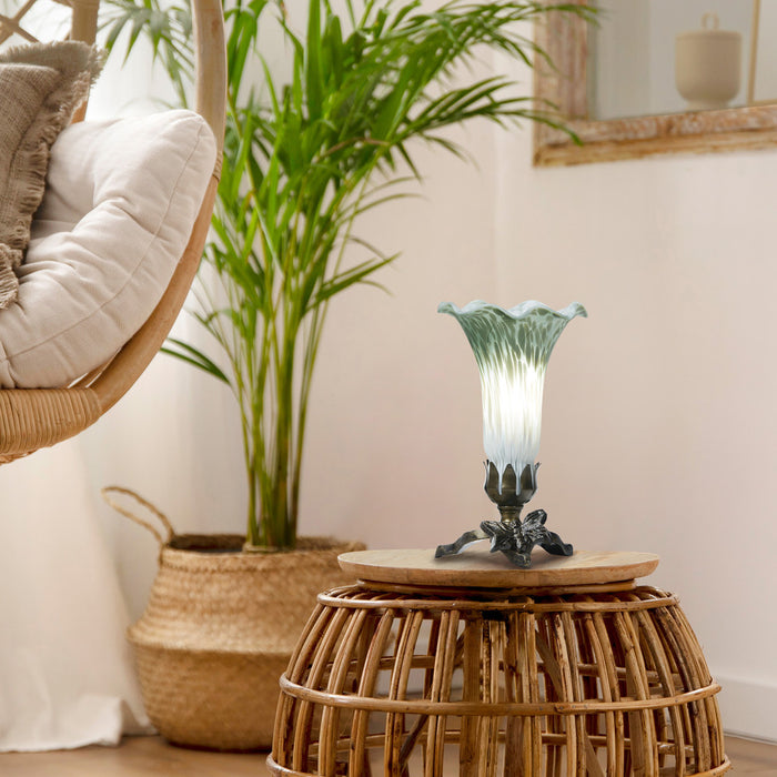 8" H Lily Glass Accent Lamp on a wooden stool with a plant and chair in the background