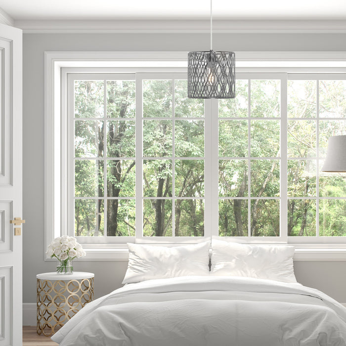 8.13"W Sami Metal Pendant Light With Silver-Tone Shade in a neatly made bed in a bedroom with large windows showing trees outside.