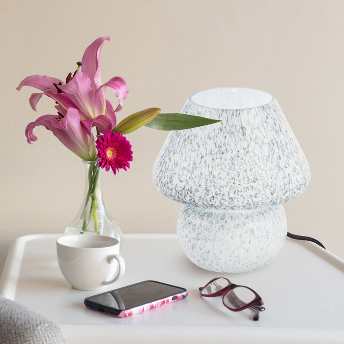 8.75" H Celeste Green/Blue/White Glass Mushroom Accent Lamp on a table with flowers, cup, phone, and glasses.