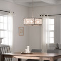 8"H Dixsie Woodgrain Finish Metal Caged Farmhouse 4-Light Chandelier in a dining room hanging above a wooden table.