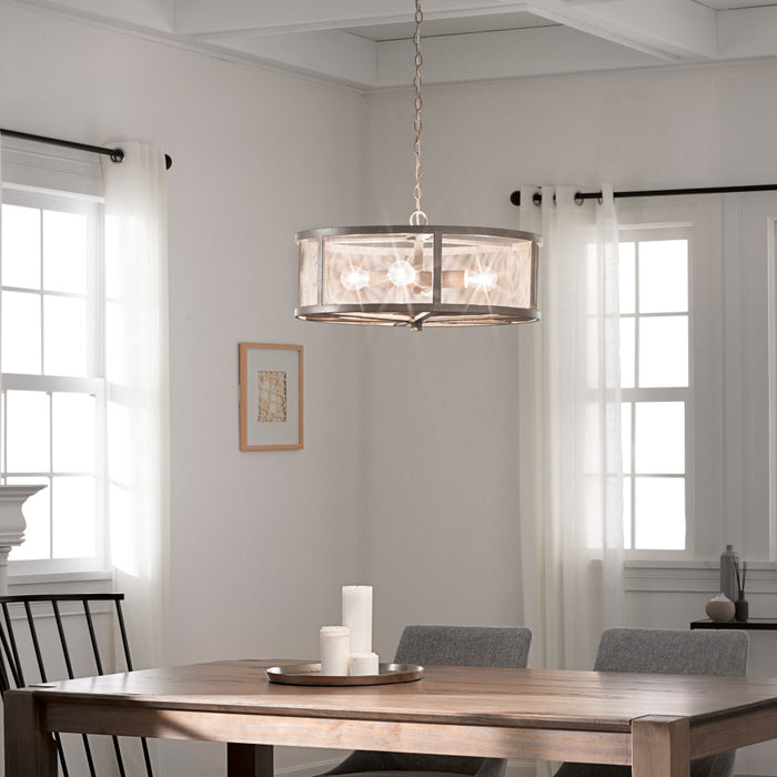 8"H Dixsie Woodgrain Finish Metal Caged Farmhouse 4-Light Chandelier in a dining room hanging above a wooden table.