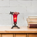 9" H Hand Blown Mercury Glass Butterfly Lily Lamp - Red on a wooden surface with books in the background.