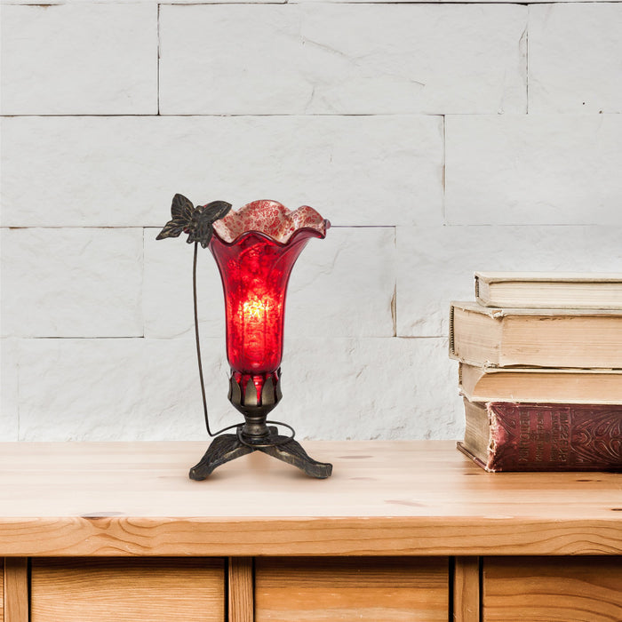 9" H Hand Blown Mercury Glass Butterfly Lily Lamp - Red on a wooden surface with books in the background.