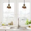 9.25" Asymmetrical Golden Glass 1-Light Pendant in a modern kitchen with sink and decorative items.