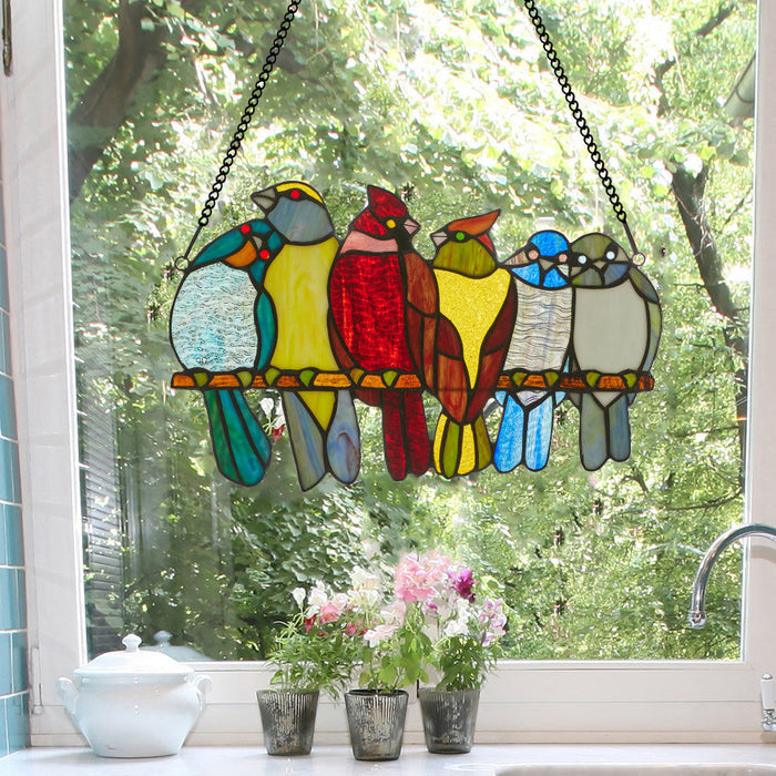 9.5"H Birds in Love Stained Glass Window Panel hanging on a window with a view of trees.