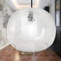 9.75" W Scottie Glam Clear Textured Glass & Black Metal Globe Shade Pendant Light in a room with blurred background