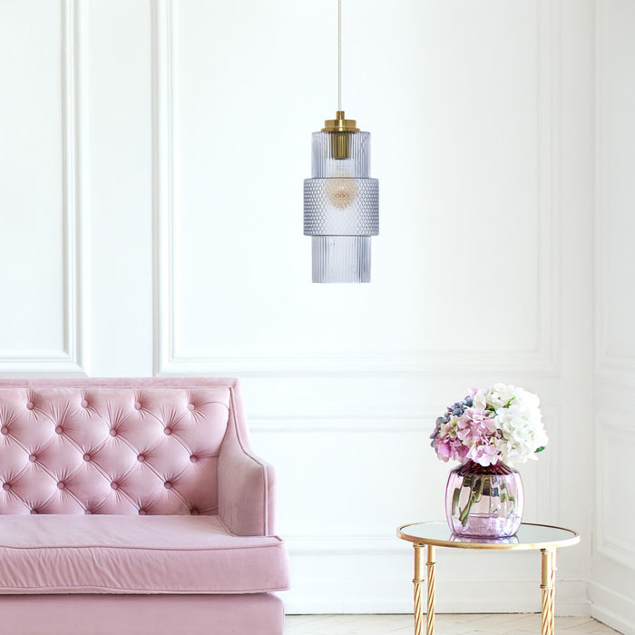 9.75"H Parker Pillar Shade Pendant Light hanging above a pink tufted sofa in a room next to a small table with flowers.