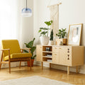 9.8" W Danielle Glam Blue/White Ombre Glass Globe Shade Pendant Light in a modern living room with a yellow armchair, wooden sideboard, and decorative plants.