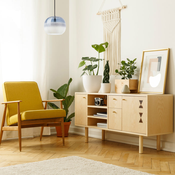9.8" W Danielle Glam Blue/White Ombre Glass Globe Shade Pendant Light in a modern living room with a yellow armchair, wooden sideboard, and decorative plants.