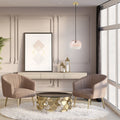 9.8" W Danielle Glam Pink/White Ombre Glass Globe Shade Pendant Light in a modern living room with two beige armchairs, a gold coffee table, and decorative elements.