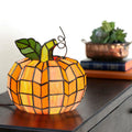 9"H Patch the Pumpkin Stained Glass Accent Lamp on a surface with a blurred background