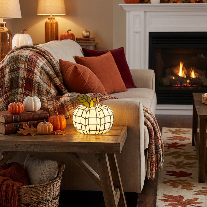 9"H Patch the Pumpkin Stained Glass Accent Lamp in a cozy living room with a fireplace, decorated for fall with pumpkins and warm lighting.