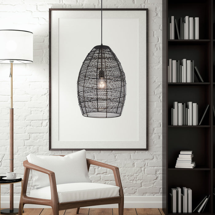 Alessia Black Metal Cone-Shaped Woven Pendant Lamp in a modern interior with a white armchair and bookshelf.