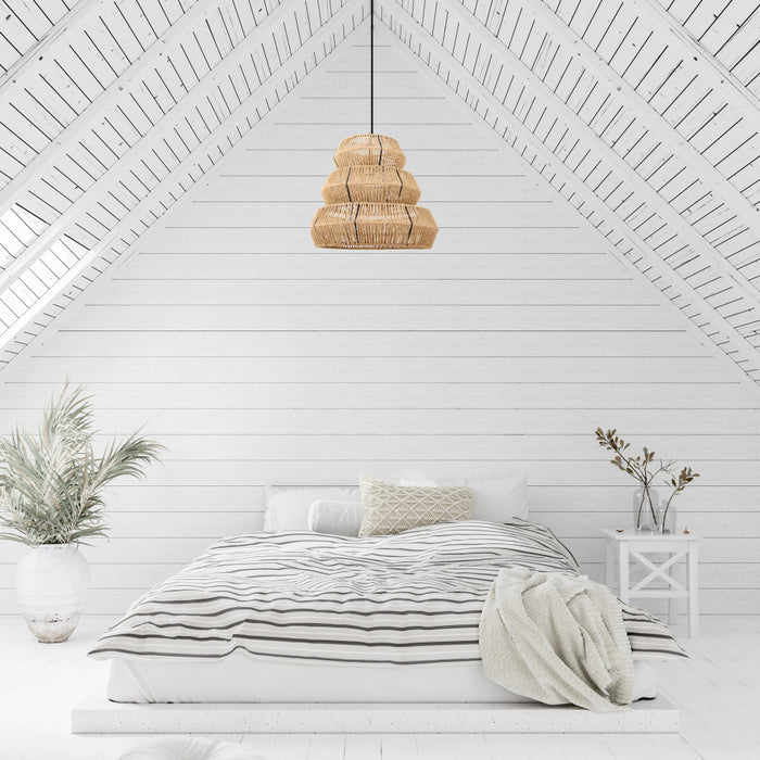 Brigitta 20"W Tiered Natural Jute Pendant Light in a neatly made bed with striped bedding in a room with white walls