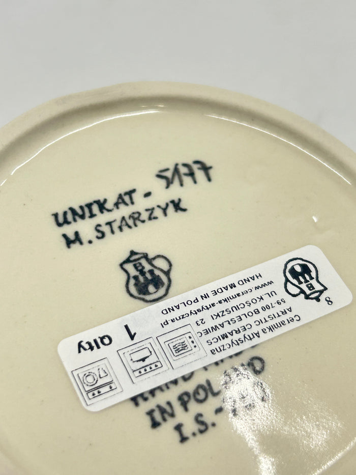 Bottom of a round Ceramika Artystyczna Polish pottery trinket box showing the Unikat 5177 stamp, M. Starzyk artist name, Ceramika Artystyczna's logo, and 1st Quality sticker.